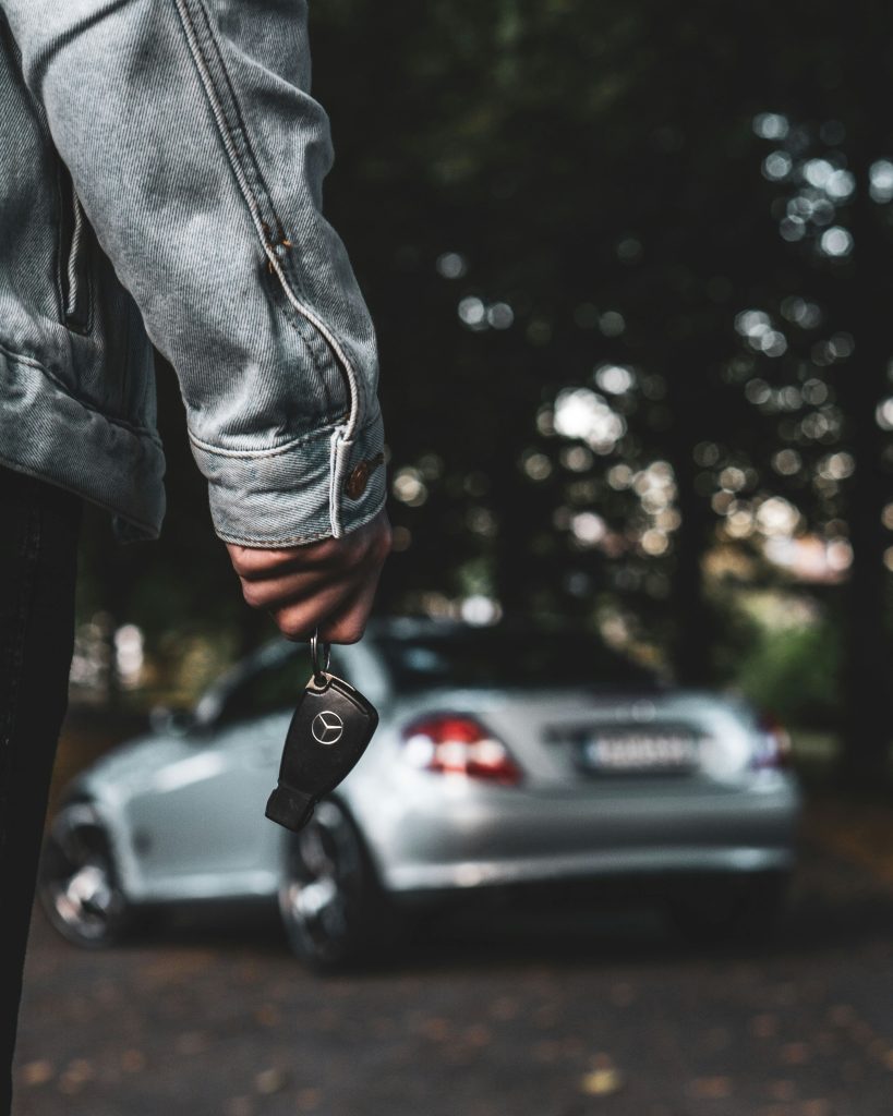 Driver consulting a luxury car lemon law attorney about a buyback